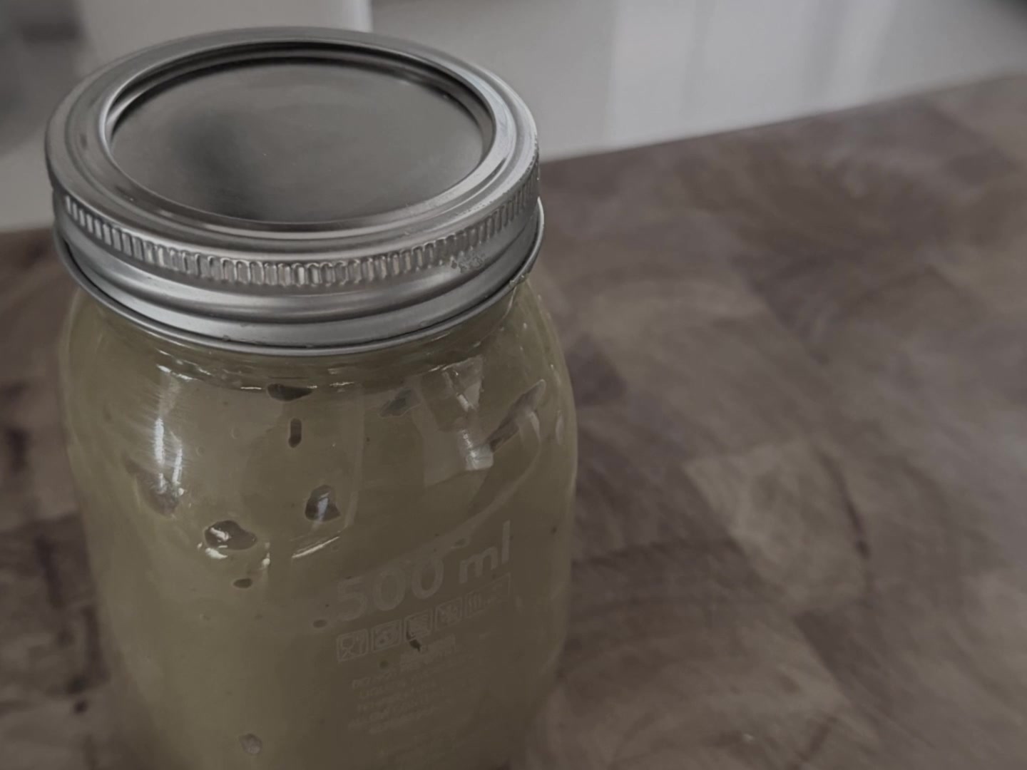 A glass jar of finished homemade vegetable stock paste made in the Thermomix TM7.